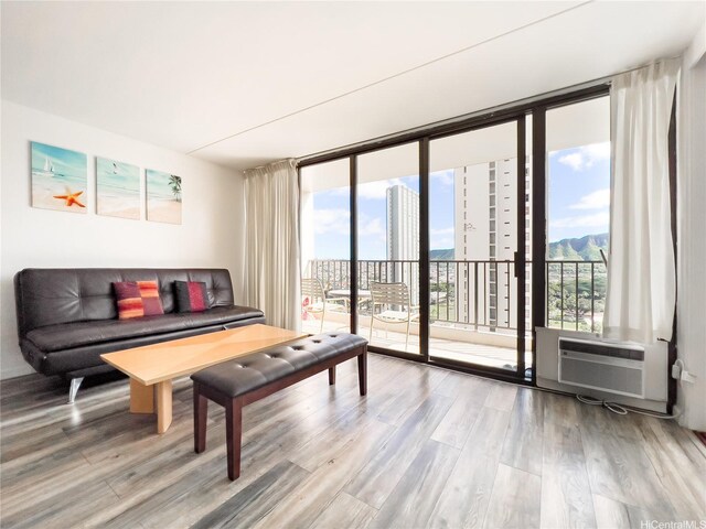 201 Ohua Ave Unit 1803, Honolulu, HI 96815 - living area featuring wood finished floors, expansive windows, and cooling unit