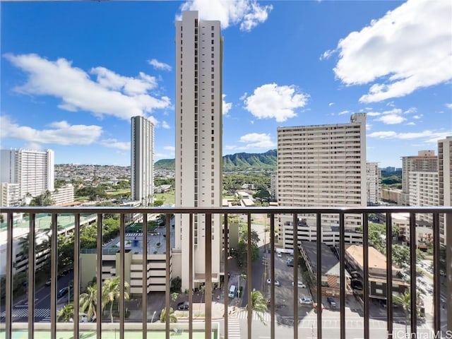 balcony with a view of city and a mountain view