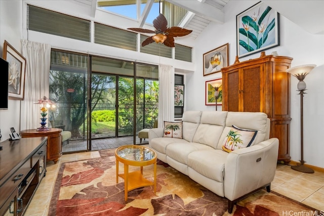 interior space with vaulted ceiling with beams and ceiling fan