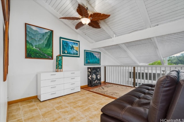 living room featuring vaulted ceiling with beams, light tile patterned flooring, a ceiling fan, and baseboards