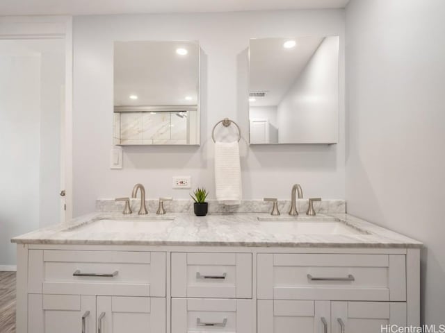 full bathroom featuring recessed lighting, visible vents, a sink, and double vanity