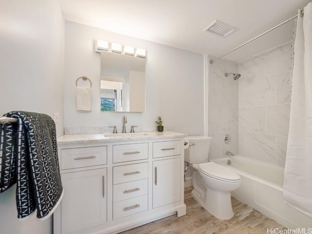 full bath featuring shower / bath combo, visible vents, toilet, wood finished floors, and vanity