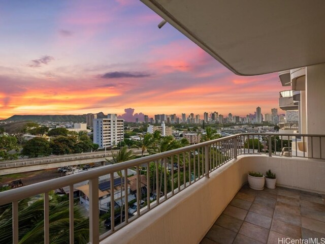 balcony at dusk with a view of city