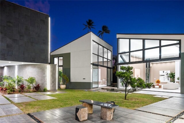 view of front of property with stucco siding and a front yard