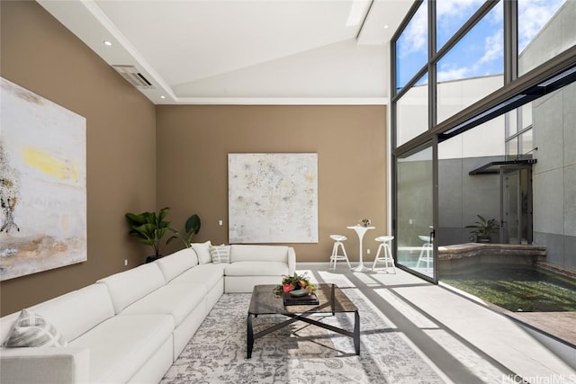 living area featuring visible vents and high vaulted ceiling