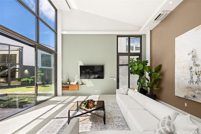 living area with floor to ceiling windows and high vaulted ceiling