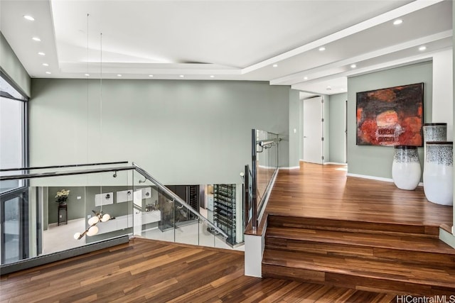 staircase with recessed lighting, baseboards, and wood finished floors