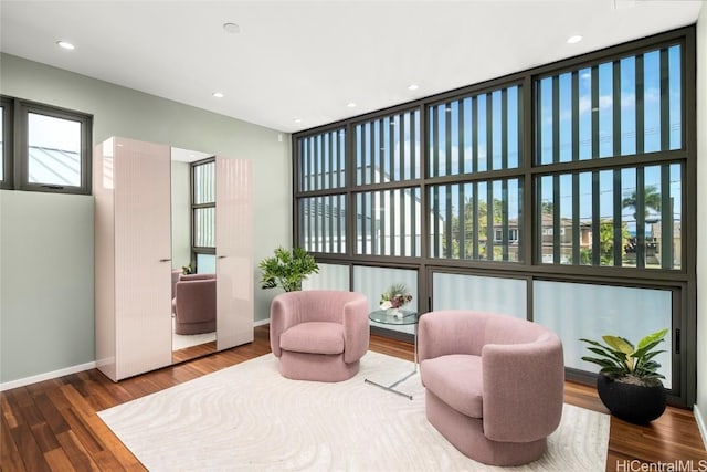 sitting room featuring recessed lighting, baseboards, and wood finished floors