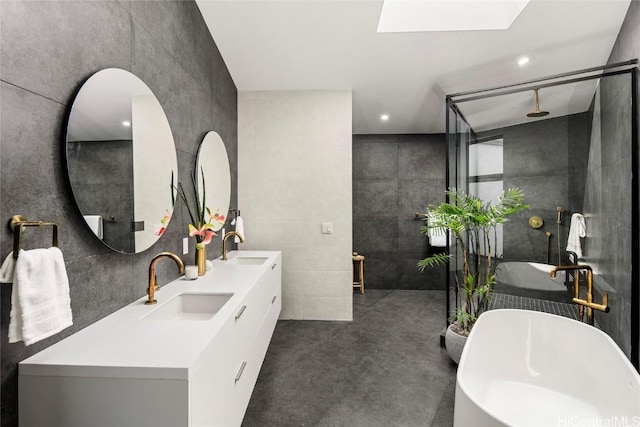 bathroom featuring a sink, a soaking tub, and a walk in shower