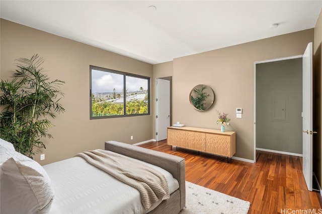 bedroom with wood finished floors and baseboards