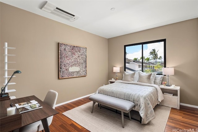 bedroom with dark wood finished floors, baseboards, and visible vents