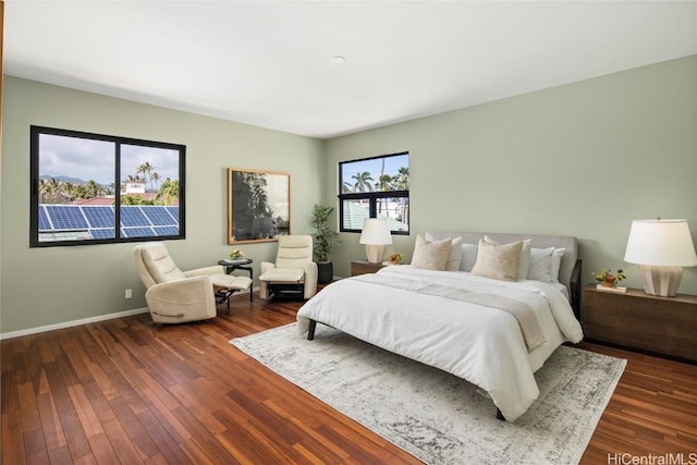 bedroom featuring dark wood-style floors and baseboards