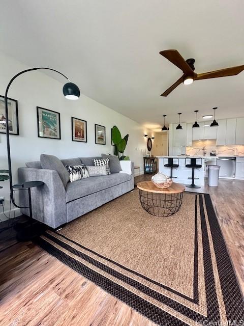 living area featuring ceiling fan and wood finished floors