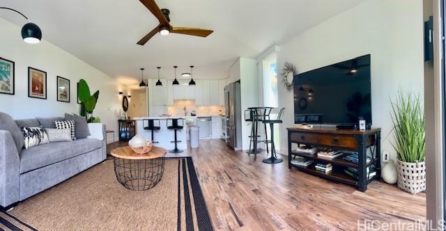 living room featuring wood finished floors and a ceiling fan