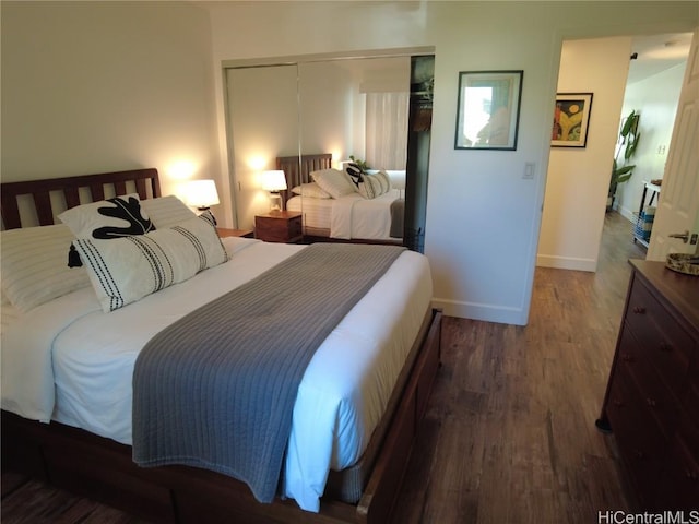 bedroom with baseboards, a closet, and wood finished floors