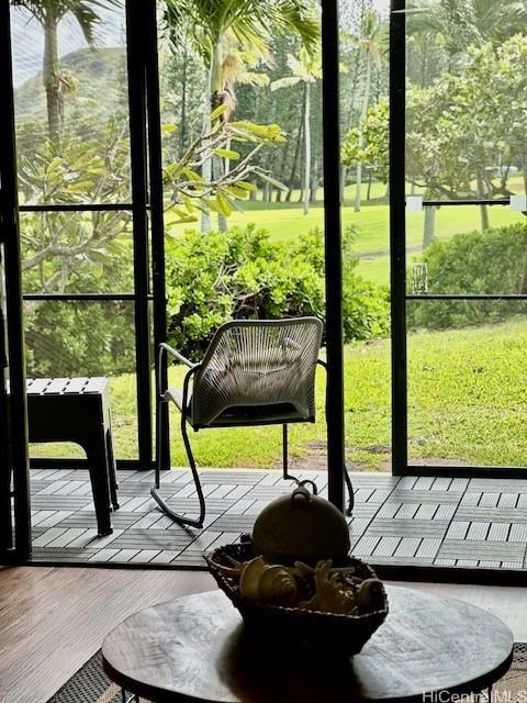 doorway to outside with wood finished floors and a wealth of natural light