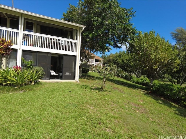 view of yard with a balcony