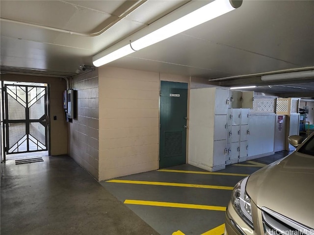 parking deck featuring concrete block wall and electric panel