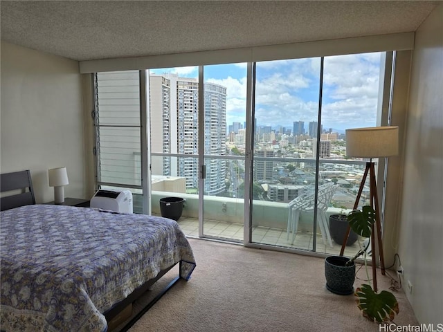 carpeted bedroom featuring a wall of windows, a city view, and a textured ceiling