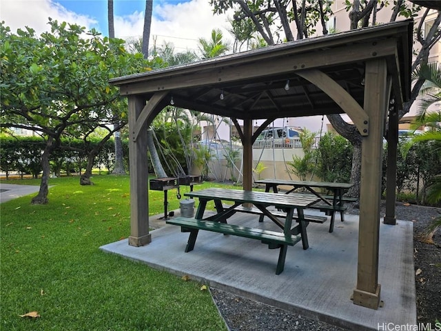 surrounding community with a gazebo, a lawn, and a patio