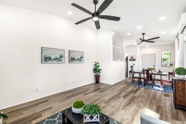 living area with wood finished floors, a ceiling fan, and recessed lighting