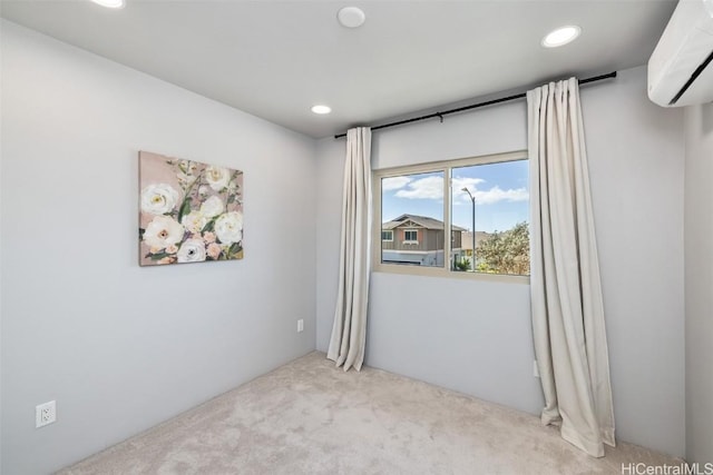 carpeted spare room featuring a wall mounted air conditioner and recessed lighting