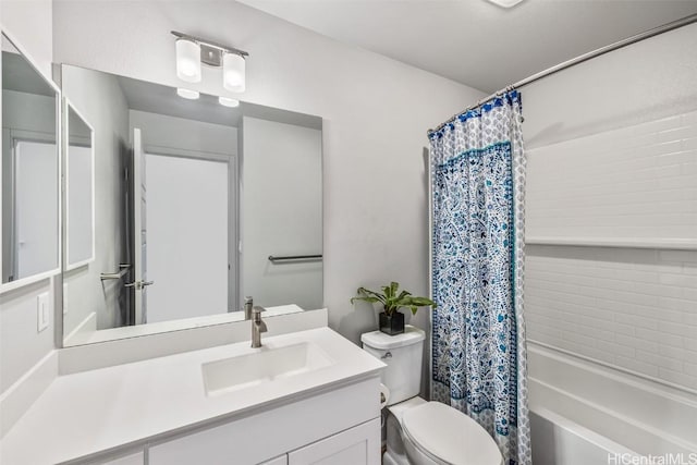 bathroom featuring toilet, shower / bath combination with curtain, and vanity