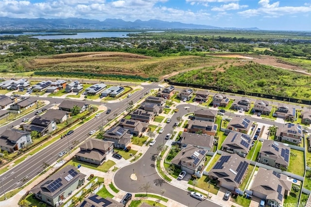 drone / aerial view featuring a residential view and a water and mountain view