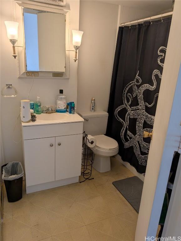 bathroom featuring a shower with curtain, vanity, and toilet