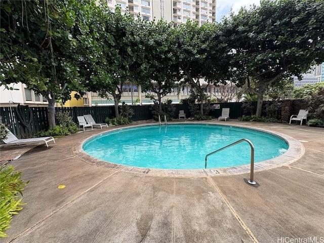 pool with fence and a patio