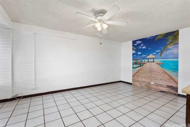 unfurnished room featuring ceiling fan, baseboards, and a textured ceiling