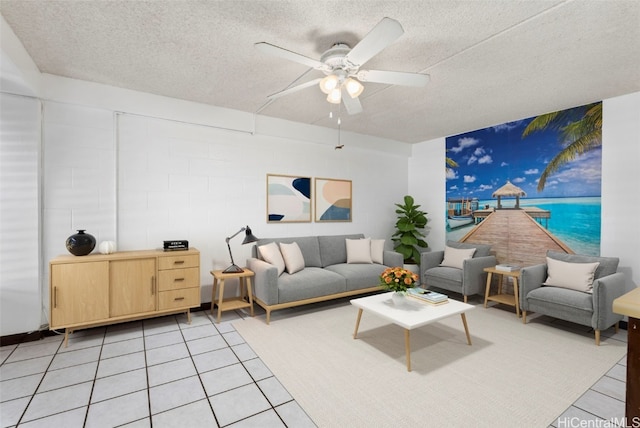 living room featuring a ceiling fan, a textured ceiling, and light tile patterned flooring