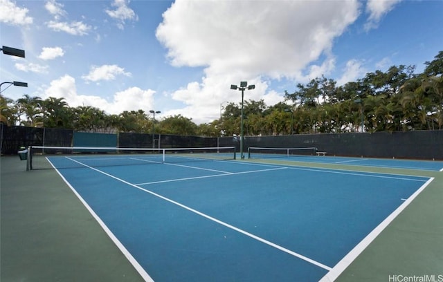 view of tennis court featuring fence