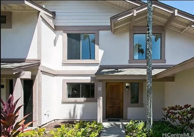 entrance to property with stucco siding