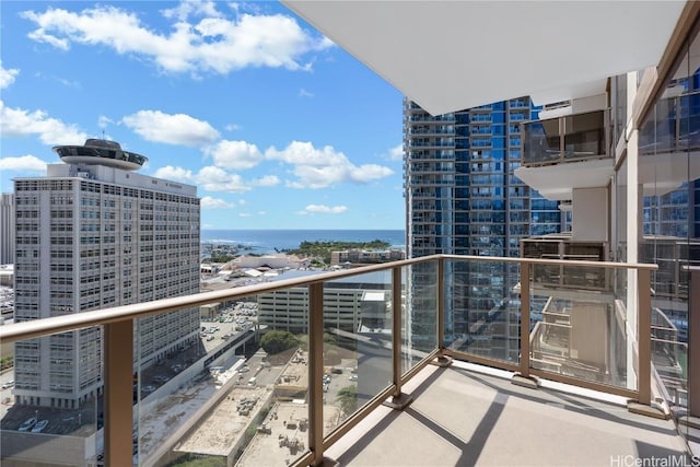 balcony with a water view and a city view