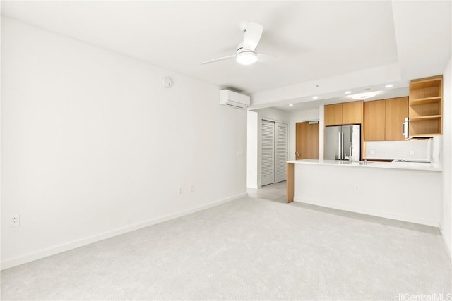 unfurnished living room featuring recessed lighting, light colored carpet, a wall mounted AC, a ceiling fan, and baseboards