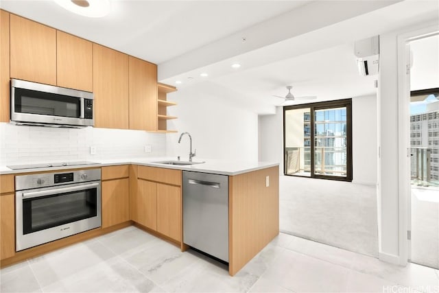 kitchen with a peninsula, a sink, appliances with stainless steel finishes, backsplash, and open shelves