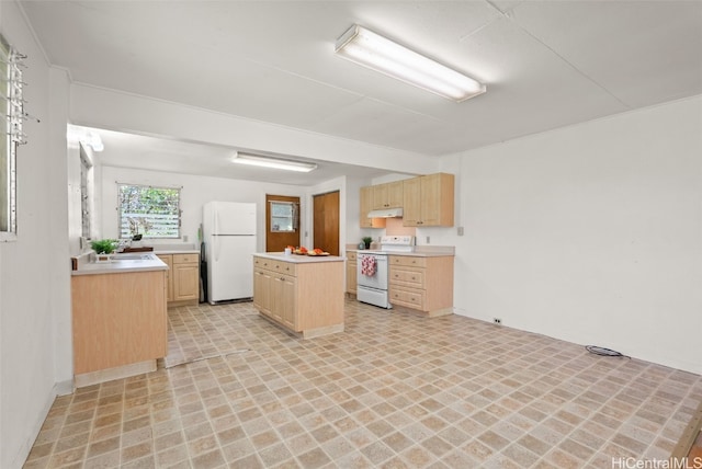 kitchen with white appliances, a kitchen island, light countertops, under cabinet range hood, and light brown cabinets