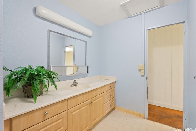 bathroom featuring baseboards and vanity