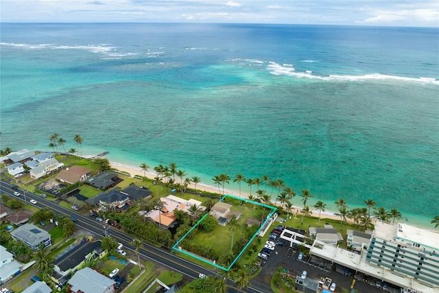 birds eye view of property featuring a water view and a view of the beach