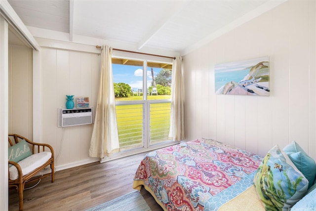 bedroom featuring beamed ceiling, cooling unit, wood finished floors, and baseboards