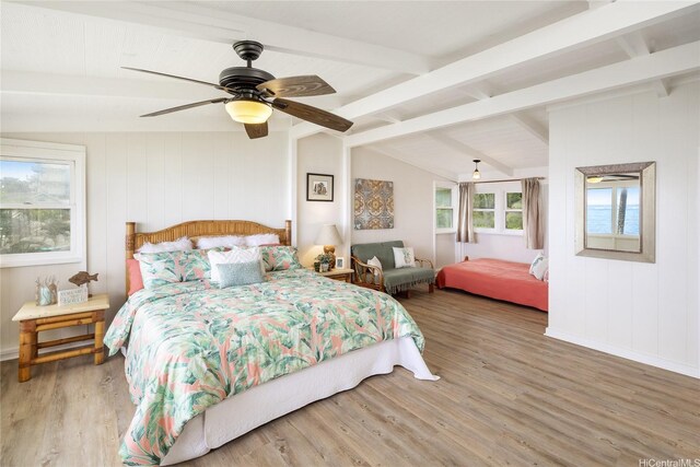bedroom with ceiling fan, wood finished floors, lofted ceiling with beams, and baseboards