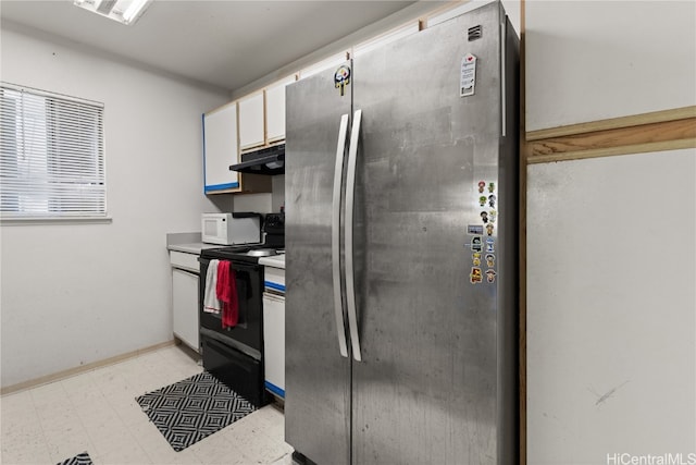 kitchen with light floors, white microwave, freestanding refrigerator, under cabinet range hood, and black / electric stove