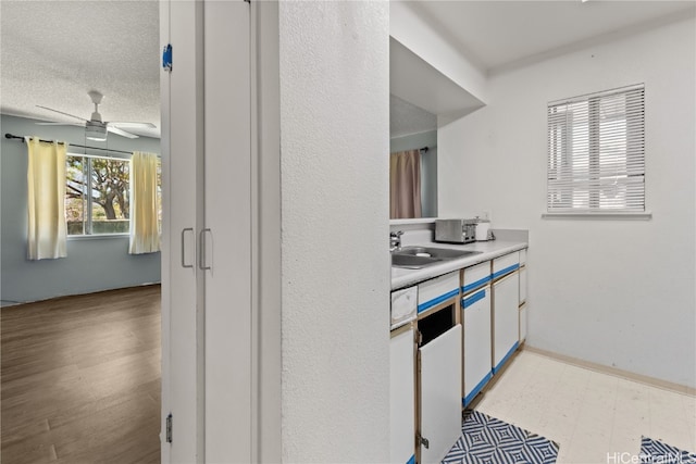 bathroom with a textured ceiling, vanity, a ceiling fan, and tile patterned floors