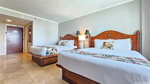 bedroom with tile patterned flooring and ornamental molding