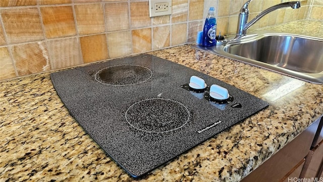 interior details with a sink and black electric cooktop