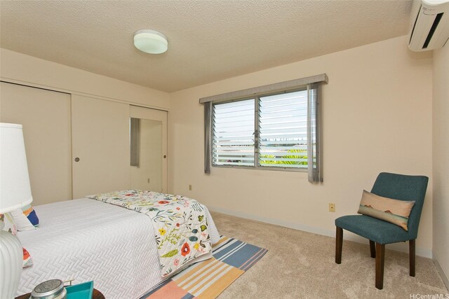 95-1050 Makaikai St Unit 14H, Mililani, HI 96789 - carpeted bedroom with a textured ceiling, a wall mounted AC, and a closet