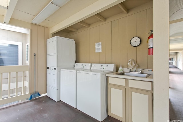 95-1050 Makaikai St Unit 14H, Mililani, HI 96789 - clothes washing area with a sink, independent washer and dryer, stacked washing maching and dryer, laundry area, and wooden walls