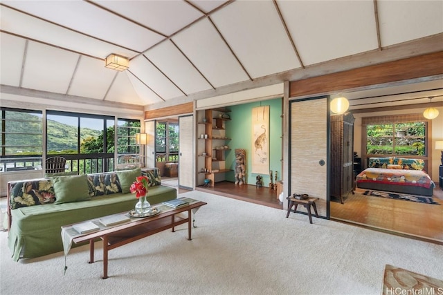 carpeted living room with lofted ceiling