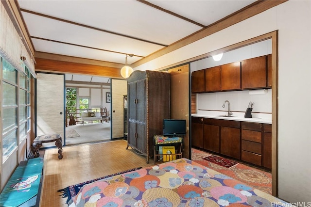 kitchen with light countertops, a sink, and light wood-style floors